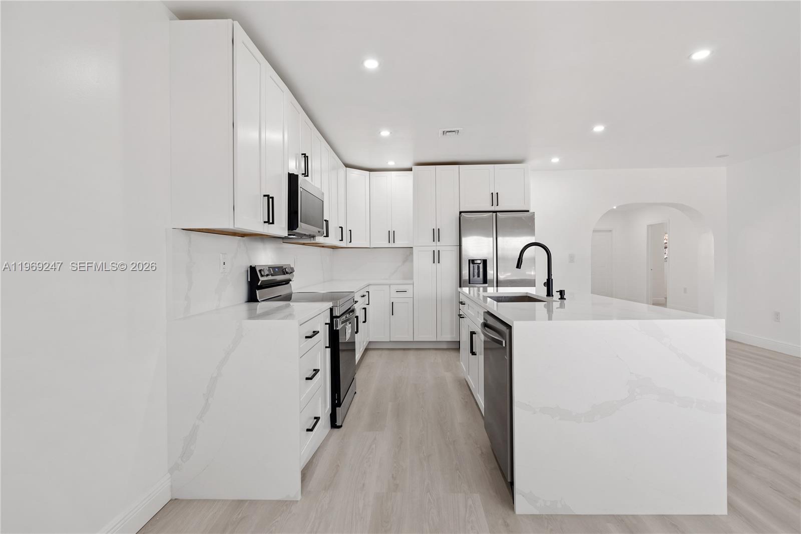 3341 Northwest 7th Street Lauderhill, FL 33311 - Photo 1 of 21 a kitchen with white cabinets and stainless steel appliances