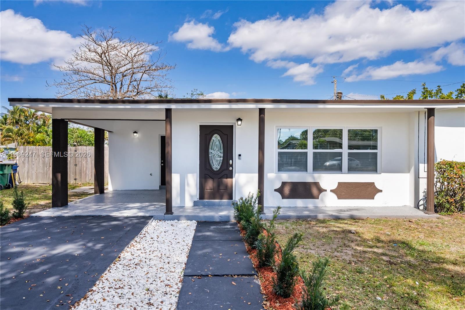 3341 Northwest 7th Street Lauderhill, FL 33311 - Photo 17 of 21 a front view of a house with a yard outdoor seating and barbeque oven