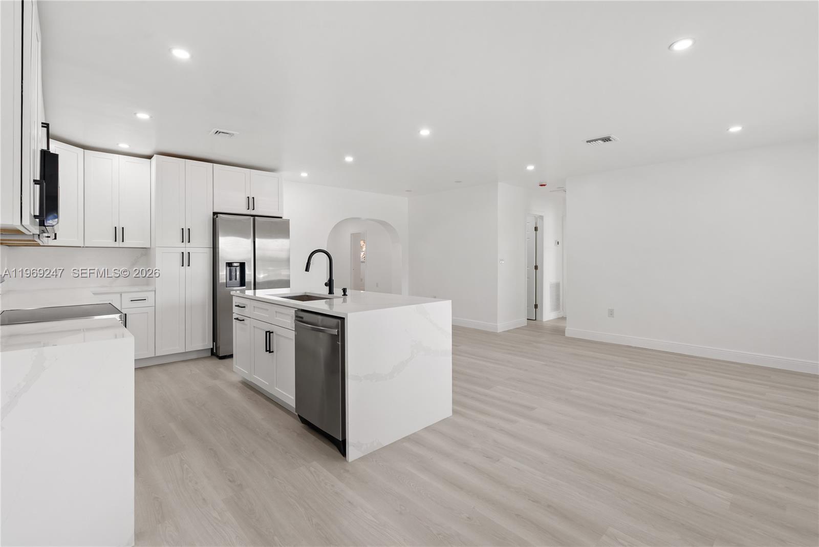 3341 Northwest 7th Street Lauderhill, FL 33311 - Photo 3 of 21 a kitchen with a sink stainless steel appliances and white cabinets