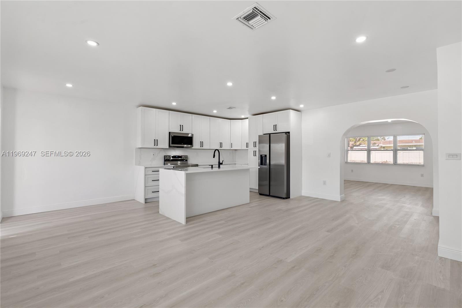 3341 Northwest 7th Street Lauderhill, FL 33311 - Photo 4 of 21 a view of a kitchen with refrigerator and windows