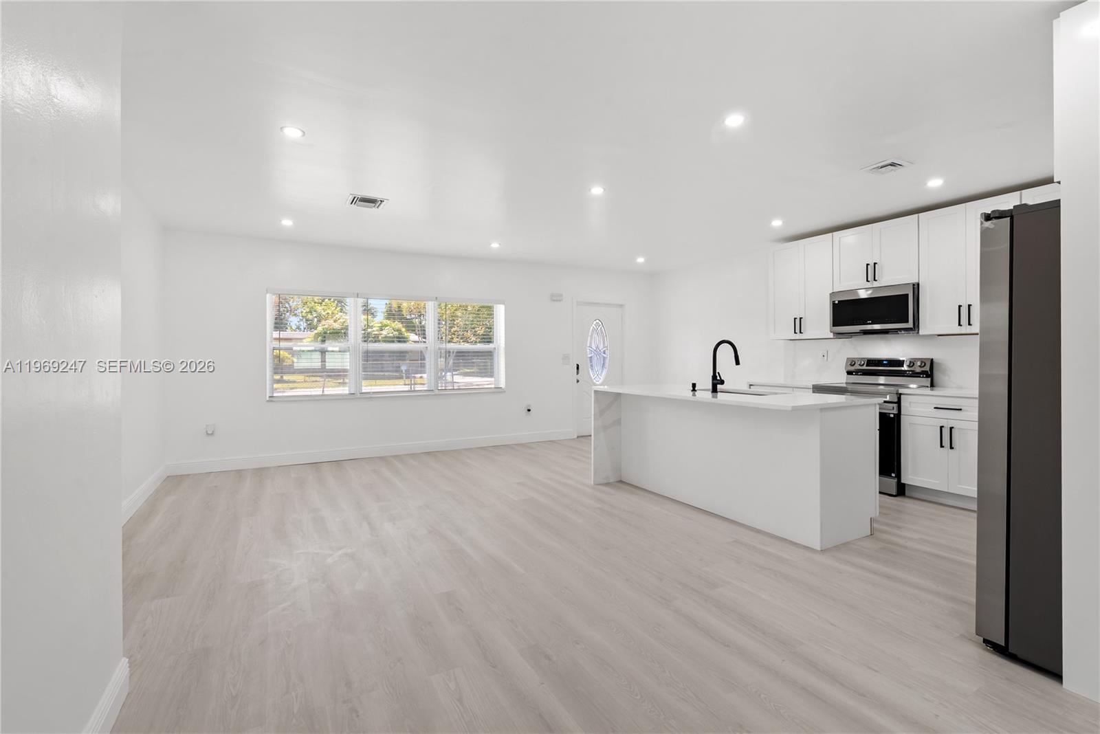 3341 Northwest 7th Street Lauderhill, FL 33311 - Photo 6 of 21 a view of a kitchen with microwave and cabinets