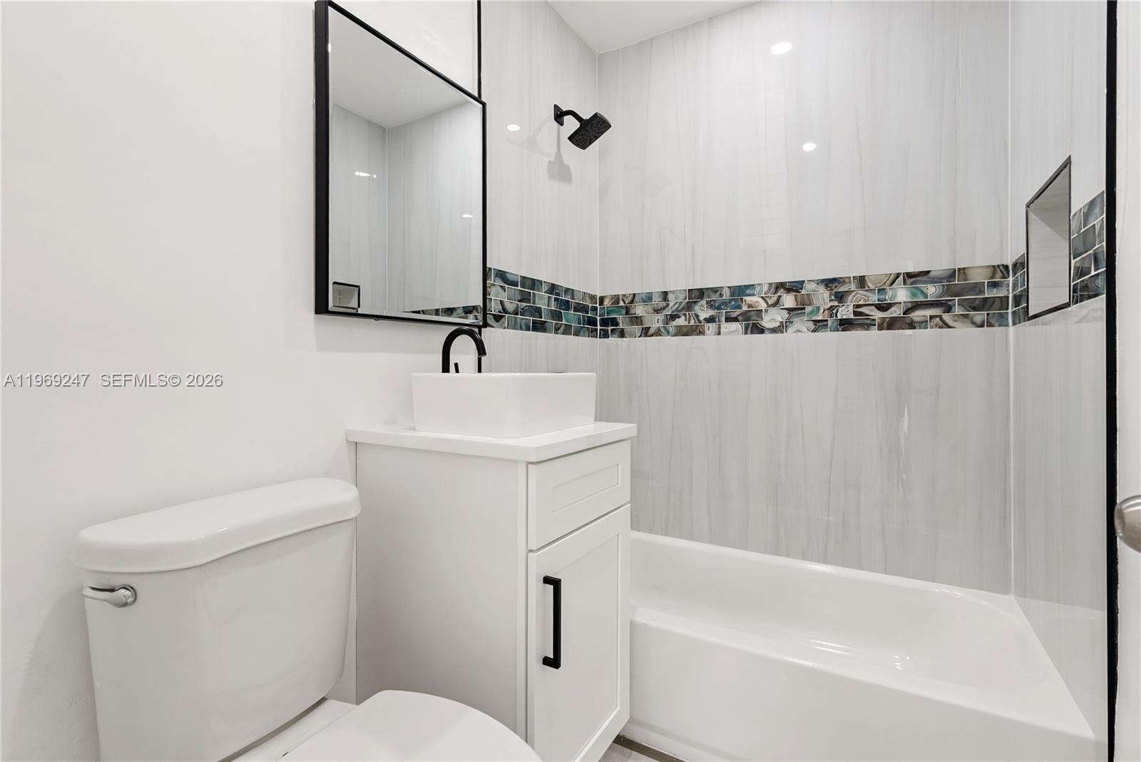 3341 Northwest 7th Street Lauderhill, FL 33311 - Photo 7 of 21 a bathroom with a sink a toilet and shower