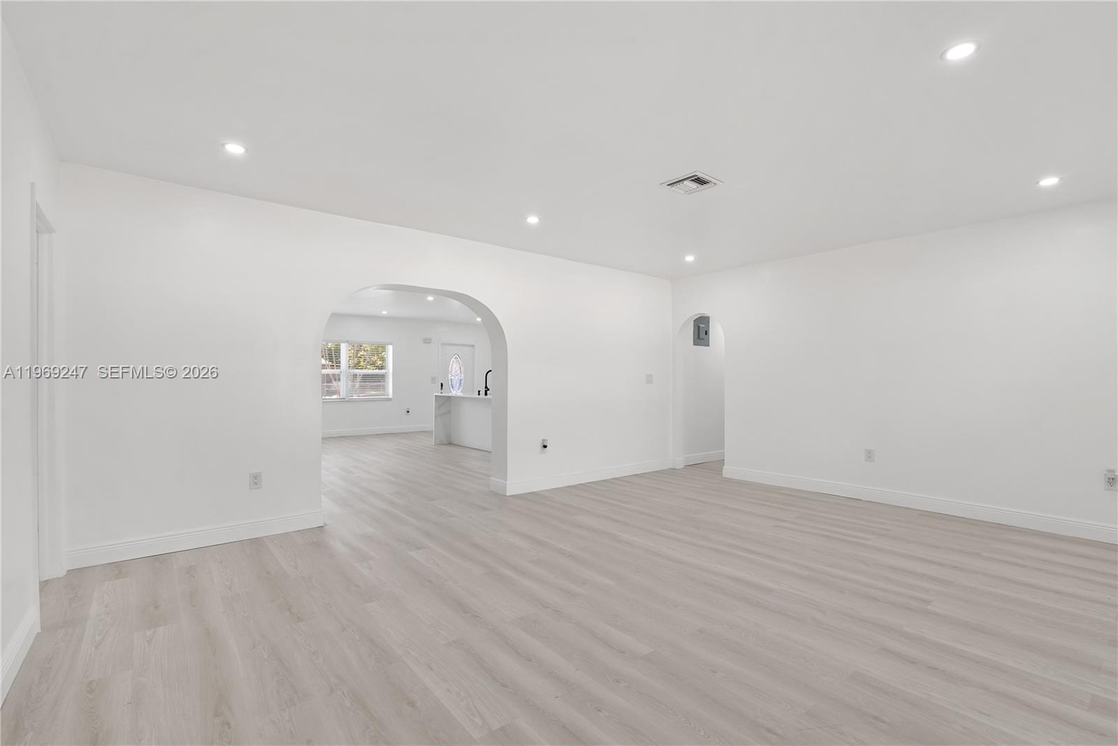 3341 Northwest 7th Street Lauderhill, FL 33311 - Photo 9 of 21 an empty room with wooden floor and windows