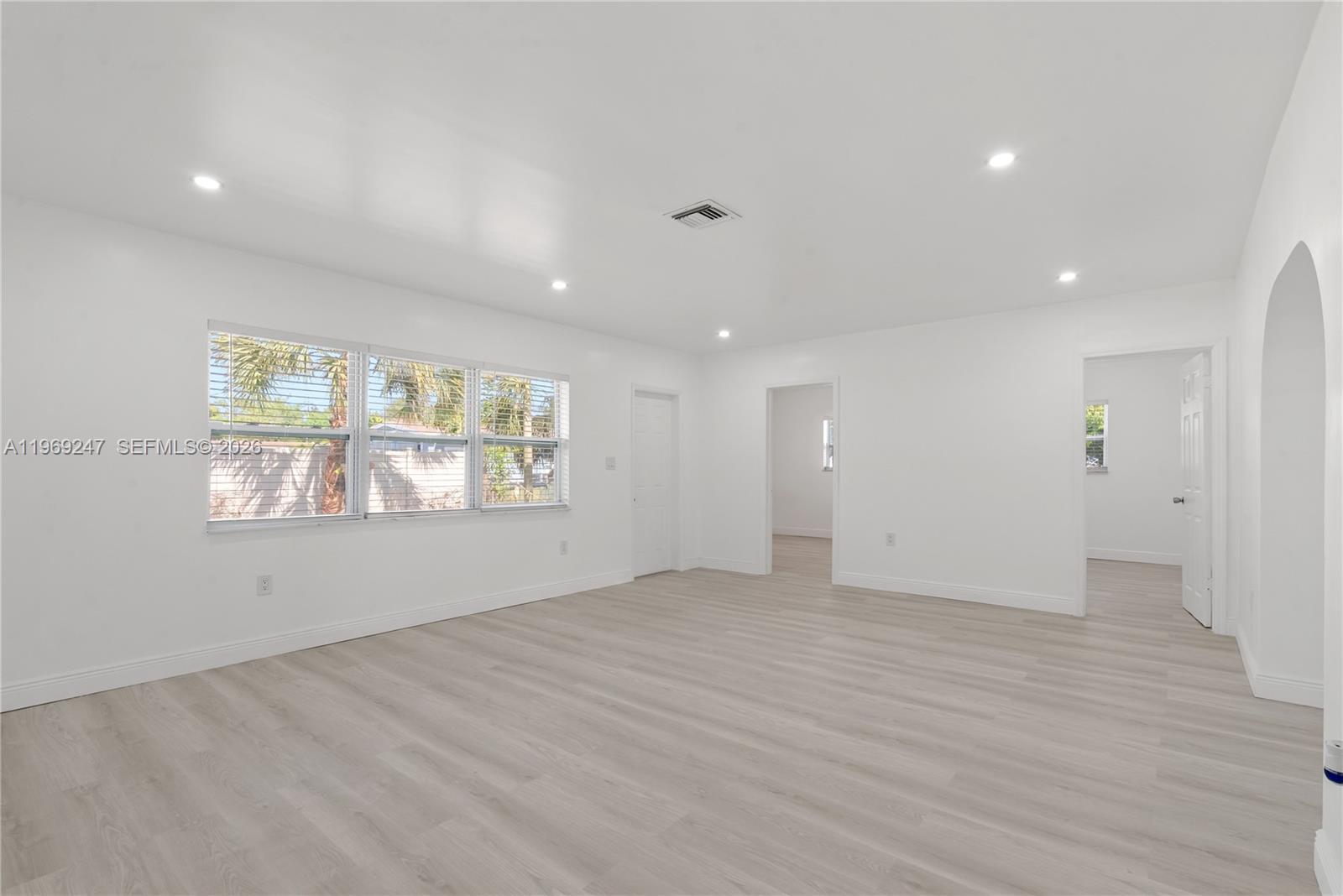 3341 Northwest 7th Street Lauderhill, FL 33311 - Photo 10 of 21 an empty room with wooden floor and windows