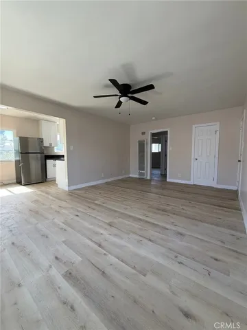 a view of a livingroom with a ceiling fan and window