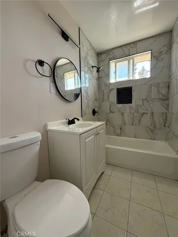 a bathroom with a toilet a sink and a mirror