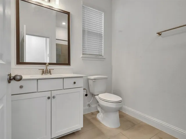 a bathroom with a sink toilet and mirror