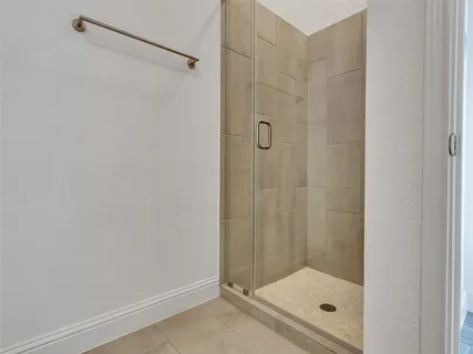a bathroom with a glass shower door
