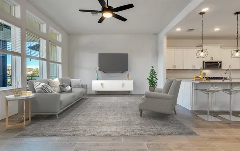 a kitchen with a sink dishwasher and white cabinets with wooden floor