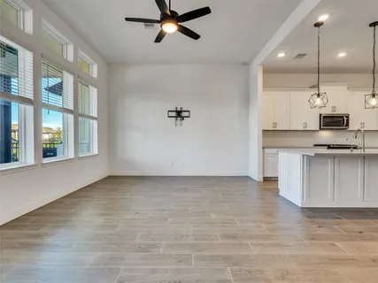 a view of kitchen with stainless steel appliances granite countertop a stove and a refrigerator