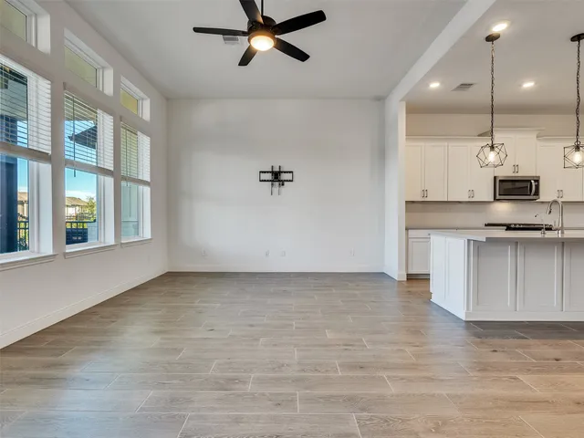 a view of kitchen with stainless steel appliances granite countertop a stove and a refrigerator