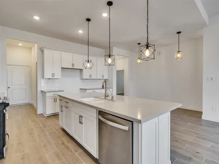 an empty room with chandelier fan and windows