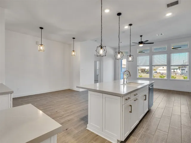 a kitchen with kitchen island a counter top space and wooden floor