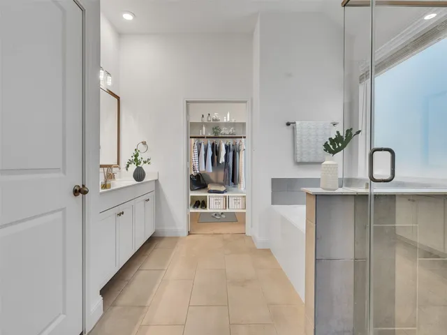 a large white kitchen with cabinets