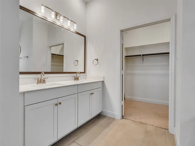 a bathroom with a double vanity sink and a mirror