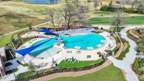 a view of a swimming pool with a yard and outdoor seating