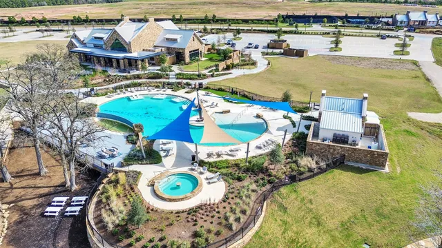an aerial view of a house with swimming pool and outdoor space