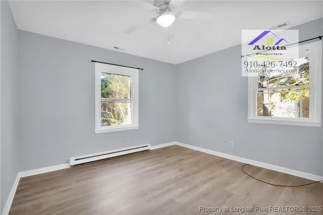 a view of room with window and ceiling fan