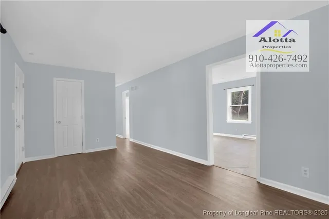 an empty room with wooden floor