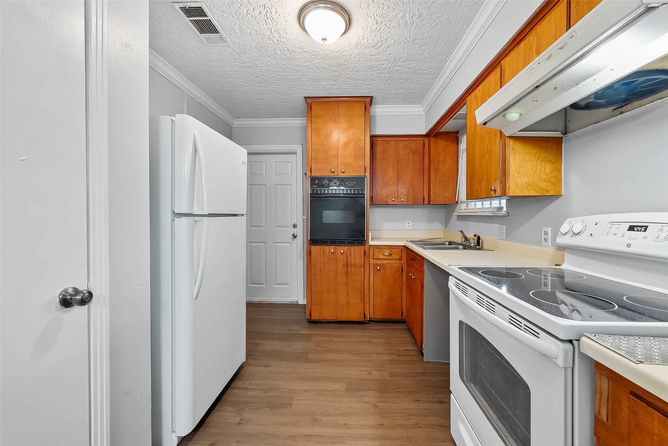 6112 Pineway Boulevard Houston, TX 77023 - Photo 11 of 21 a kitchen with a refrigerator sink stove and cabinets