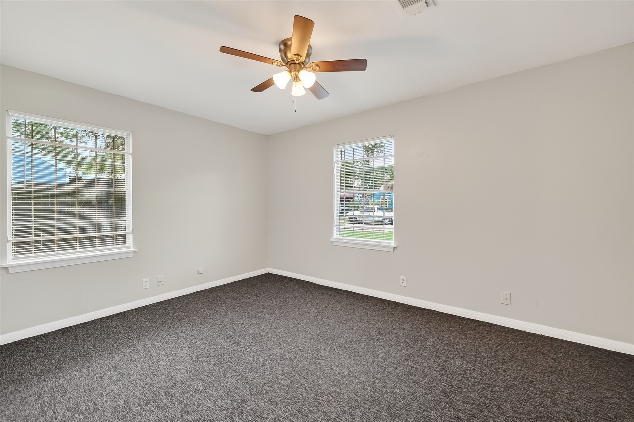 6112 Pineway Boulevard Houston, TX 77023 - Photo 14 of 21 an empty room with a window and a fan