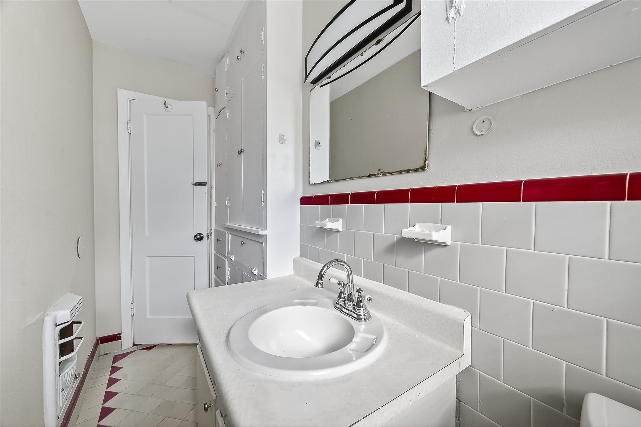 6112 Pineway Boulevard Houston, TX 77023 - Photo 19 of 21 a bathroom with a sink and a mirror