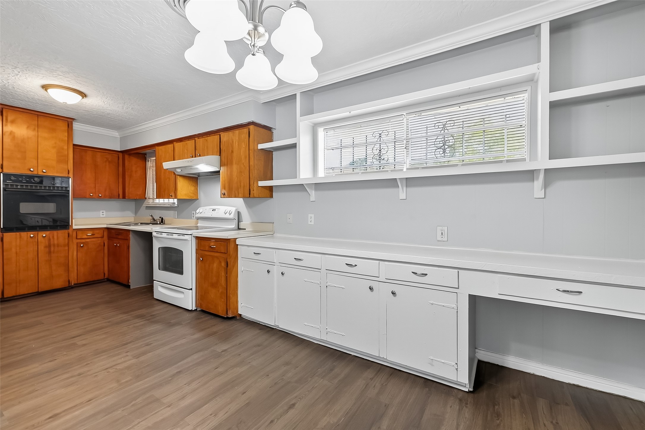 6112 Pineway Boulevard Houston, TX 77023 - Photo 8 of 21 a kitchen with stainless steel appliances granite countertop a sink cabinets a window and a counter space