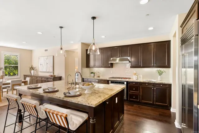 a large kitchen with a table and chairs