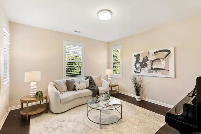 a bedroom with a large bed and a potted plant