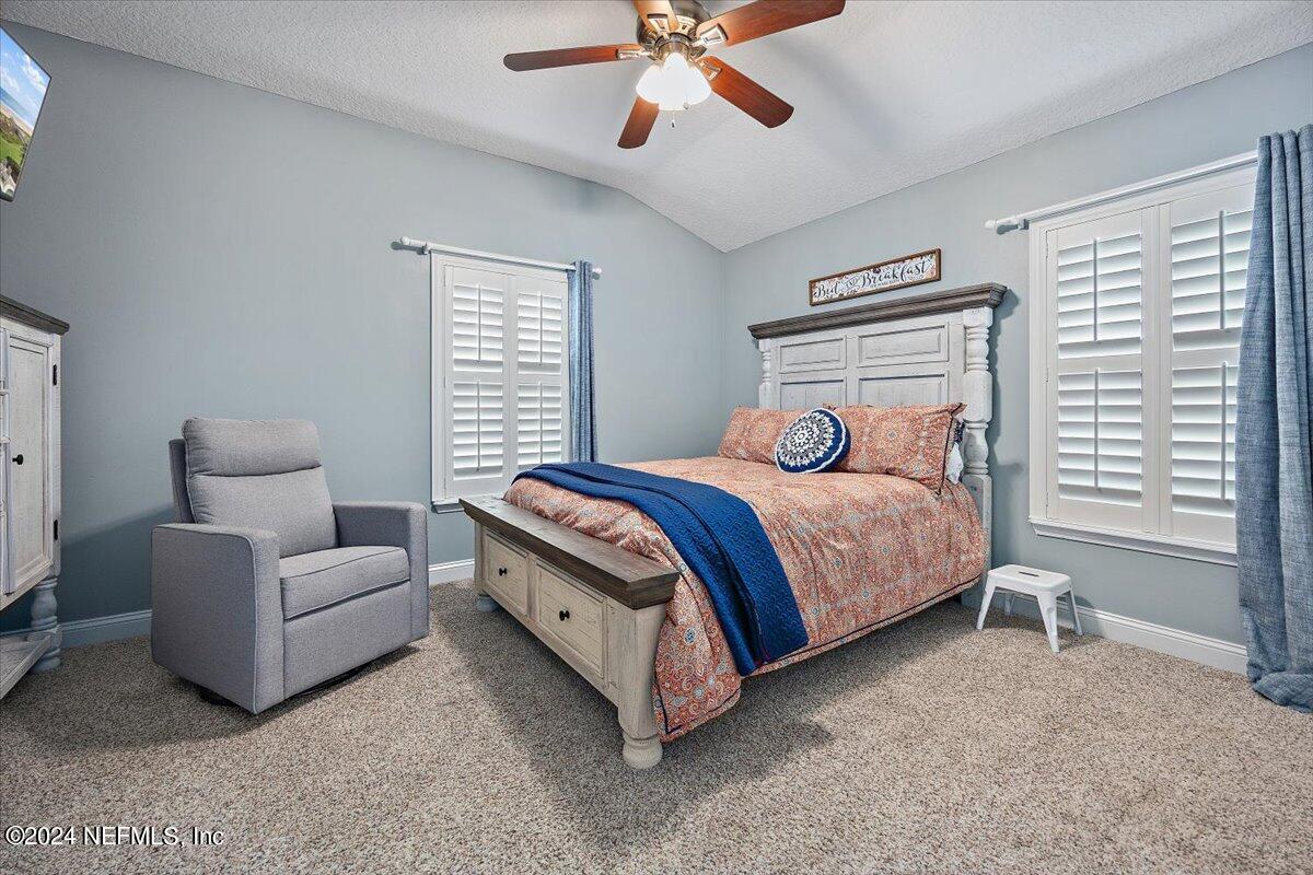 11322 Mandarin Ridge Lane Jacksonville, FL 32258 - Photo 13 of 37 a bedroom with a bed and a couch