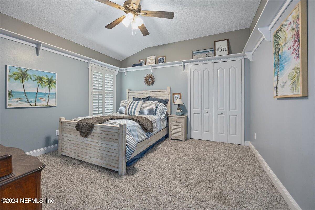 11322 Mandarin Ridge Lane Jacksonville, FL 32258 - Photo 14 of 37 a spacious bedroom with a bed and a chandelier