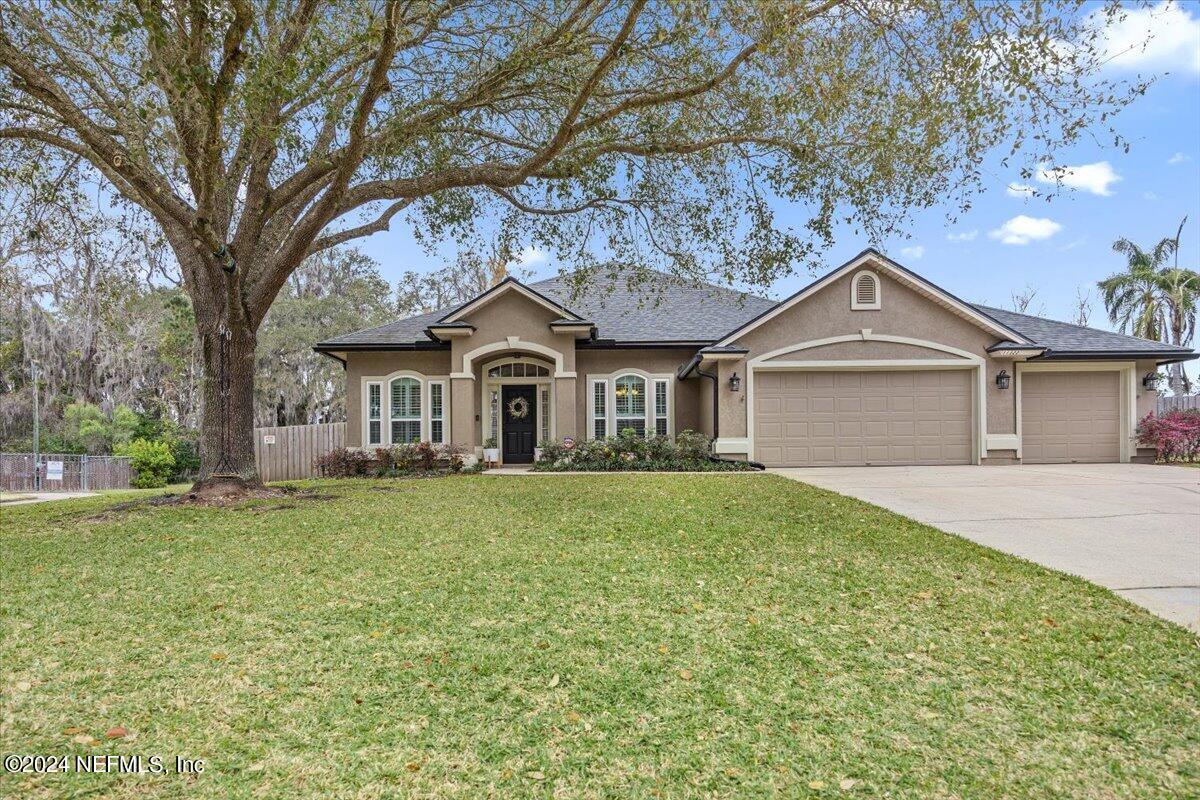 11322 Mandarin Ridge Lane Jacksonville, FL 32258 - Photo 16 of 37 a front view of a house with a garden and trees