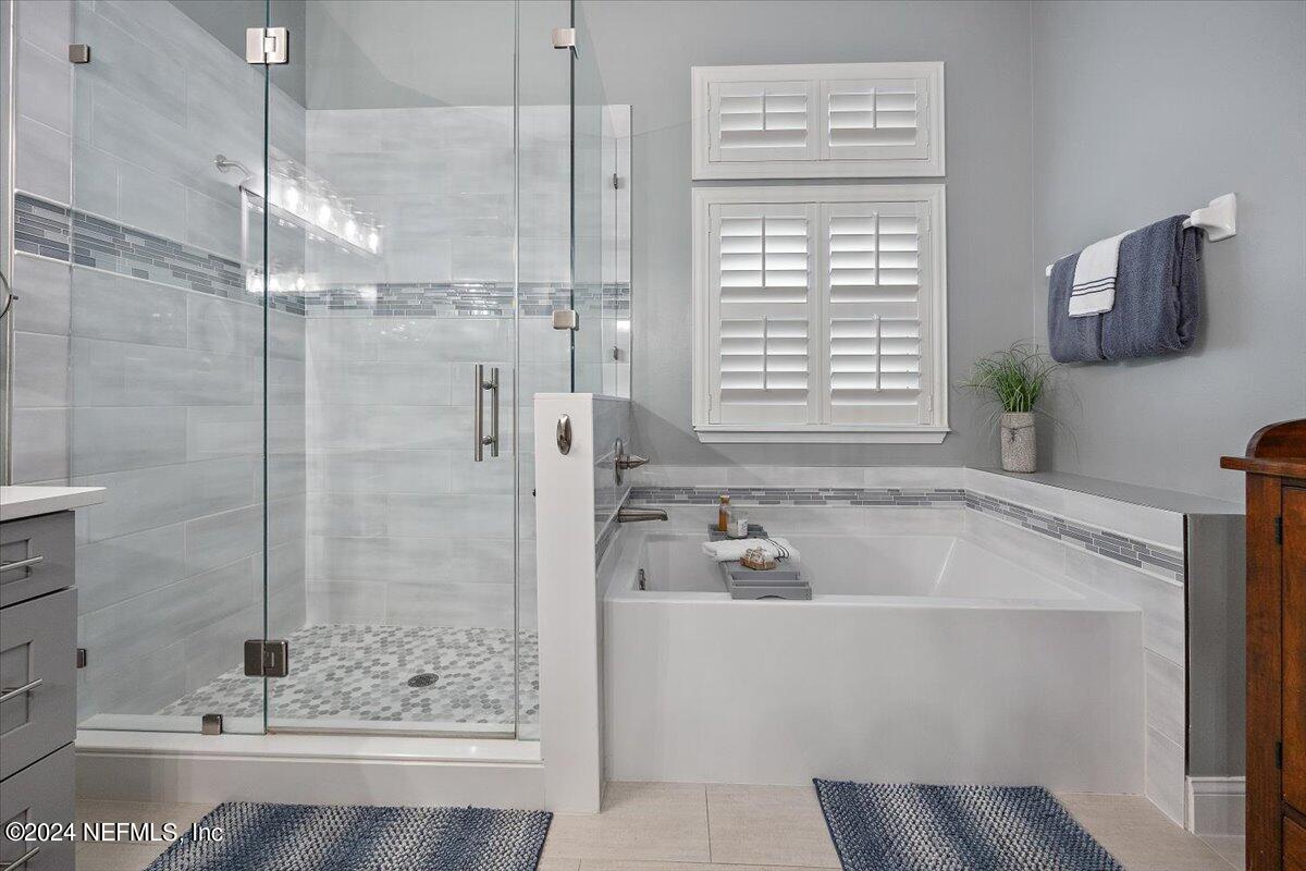 11322 Mandarin Ridge Lane Jacksonville, FL 32258 - Photo 18 of 37 a bathroom with a bathtub and a shower