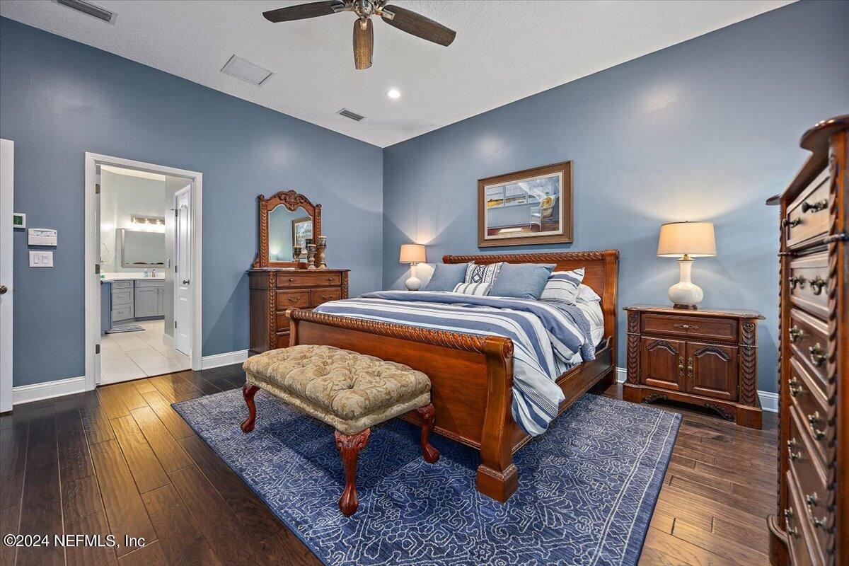 11322 Mandarin Ridge Lane Jacksonville, FL 32258 - Photo 19 of 37 a bedroom with a bed and wooden floor