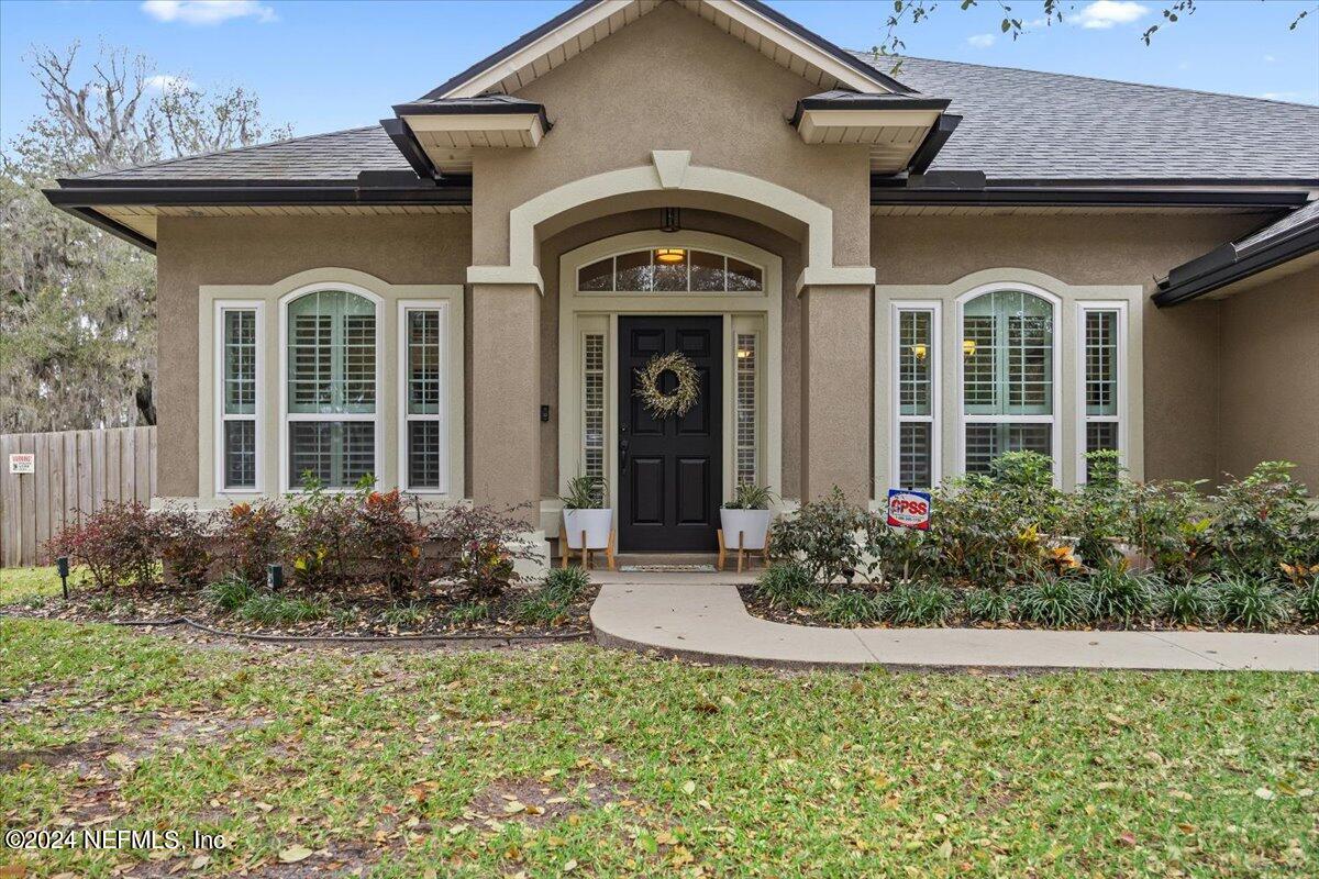 11322 Mandarin Ridge Lane Jacksonville, FL 32258 - Photo 2 of 37 a front view of a house with garden
