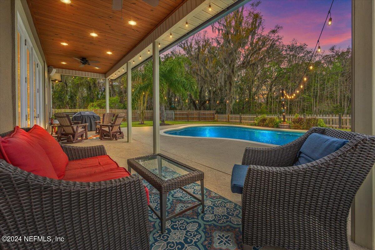 11322 Mandarin Ridge Lane Jacksonville, FL 32258 - Photo 24 of 37 a outdoor space with patio the couches and a dining table with garden view