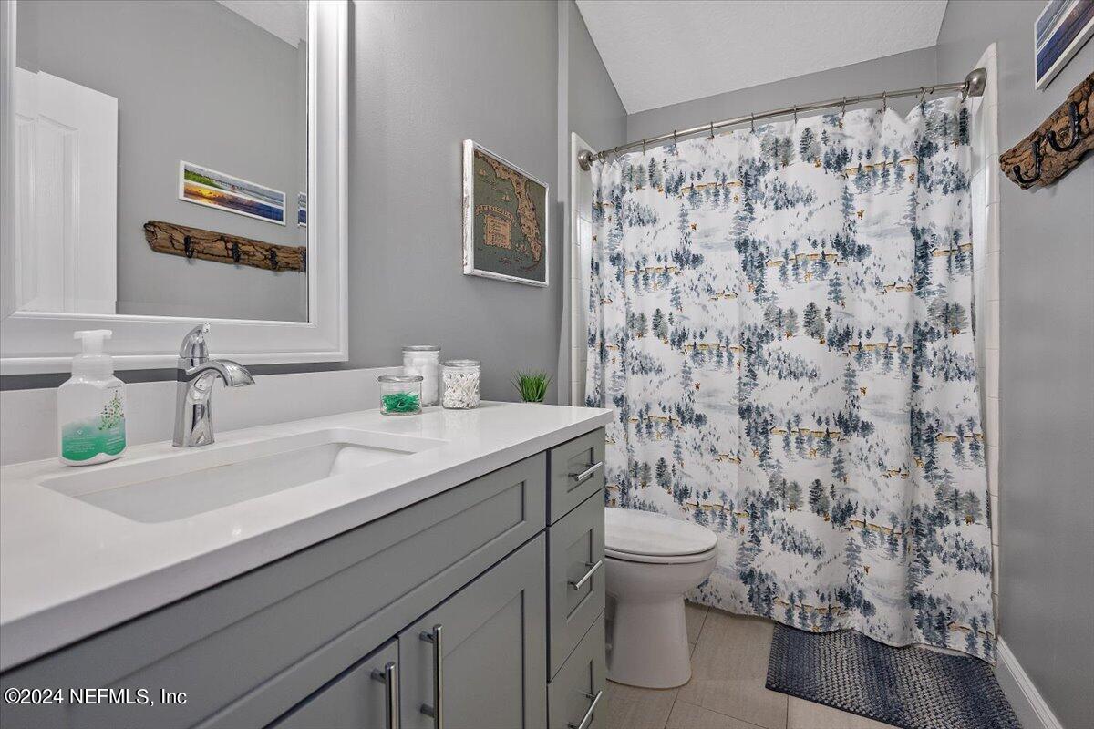 11322 Mandarin Ridge Lane Jacksonville, FL 32258 - Photo 25 of 37 a bathroom with a granite countertop sink a toilet and a mirror