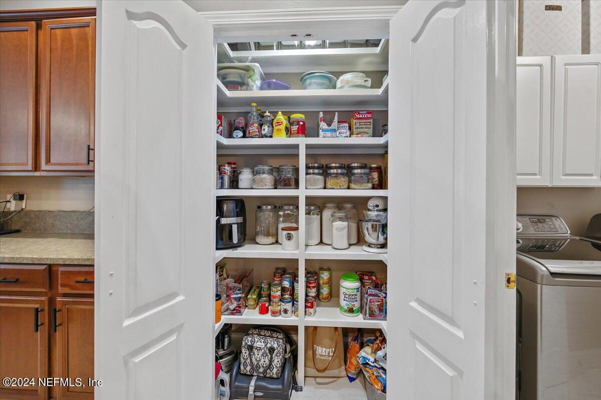11322 Mandarin Ridge Lane Jacksonville, FL 32258 - Photo 27 of 37 a room with lots of books and a refrigerator