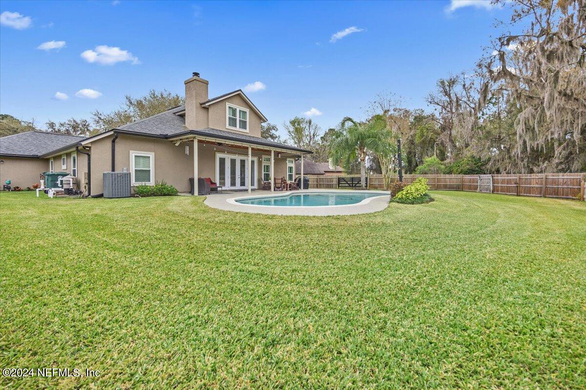 11322 Mandarin Ridge Lane Jacksonville, FL 32258 - Photo 31 of 37 a front view of a house with a garden and yard