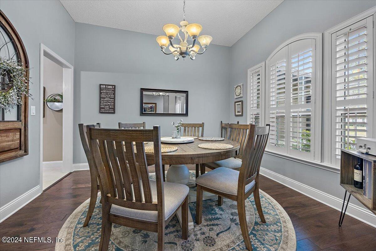 11322 Mandarin Ridge Lane Jacksonville, FL 32258 - Photo 5 of 37 a view of a dining room with furniture a chandelier and wooden floor
