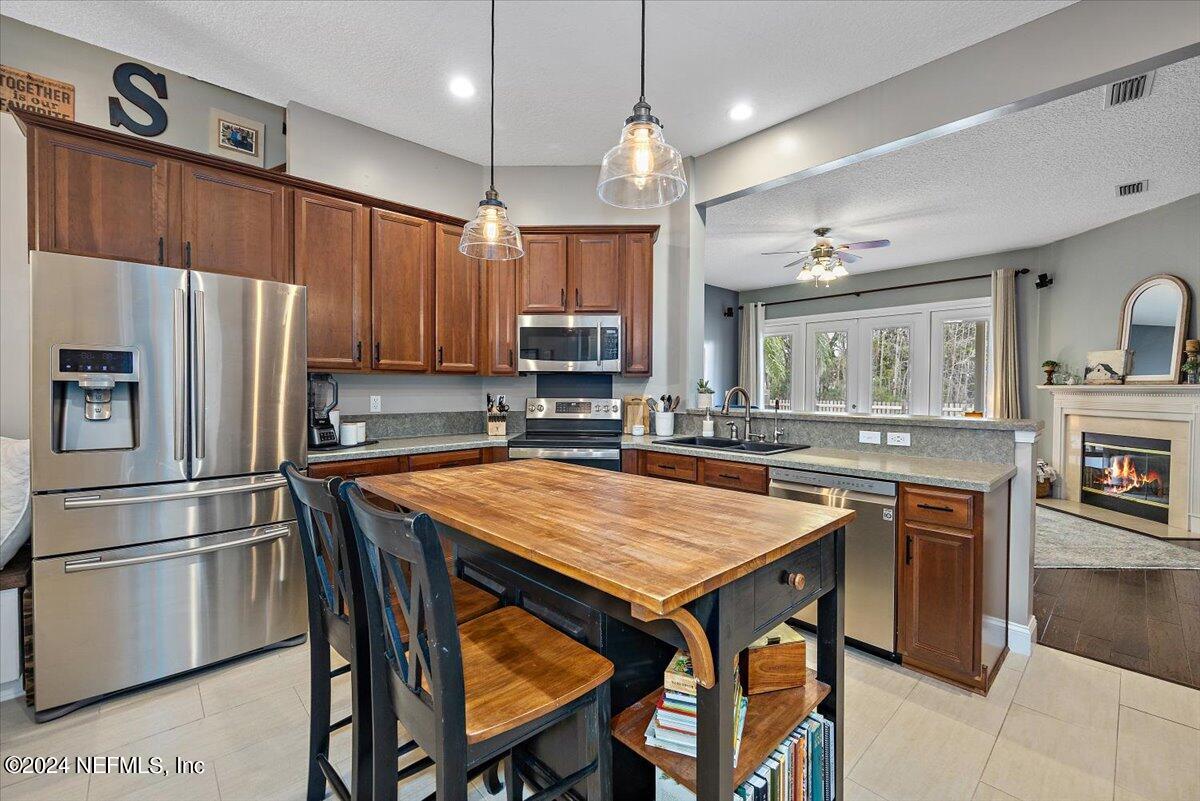 11322 Mandarin Ridge Lane Jacksonville, FL 32258 - Photo 6 of 37 a kitchen with stainless steel appliances a stove a refrigerator a sink and a refrigerator