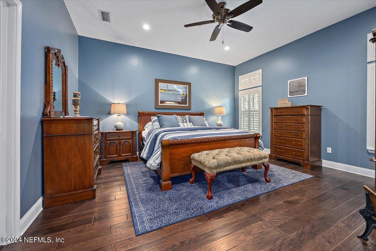11322 Mandarin Ridge Lane Jacksonville, FL 32258 - Photo 8 of 37 a bedroom with a bed and wooden floor