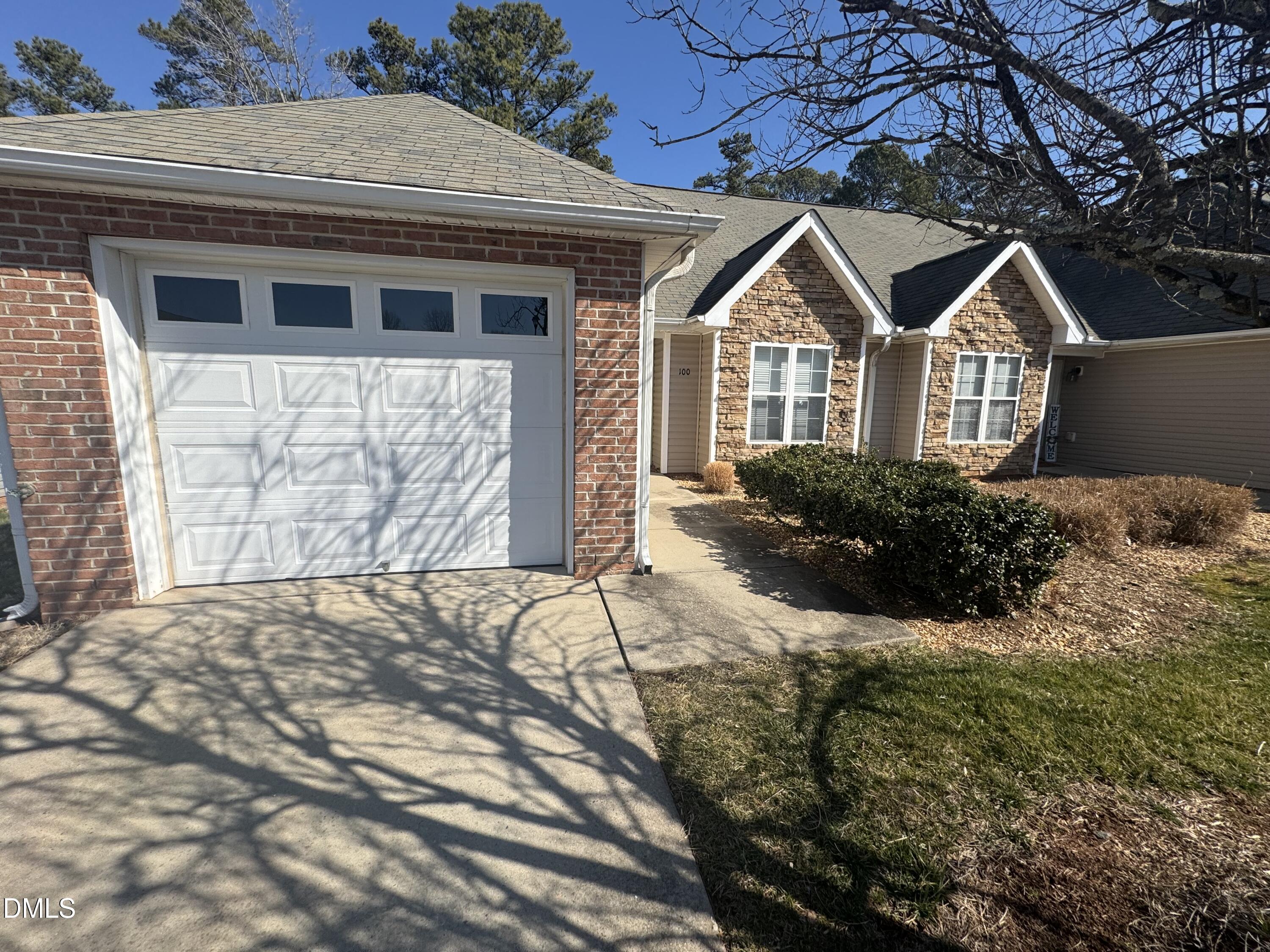 11351 Clubhaven Place, Unit 100 Raleigh, NC 27617 - Photo 2 of 29 a front view of a house with a yard and garage