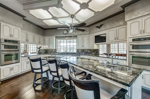 a kitchen with stainless steel appliances granite countertop a sink and cabinets