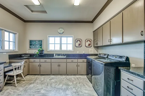 a kitchen with a sink stove and cabinets