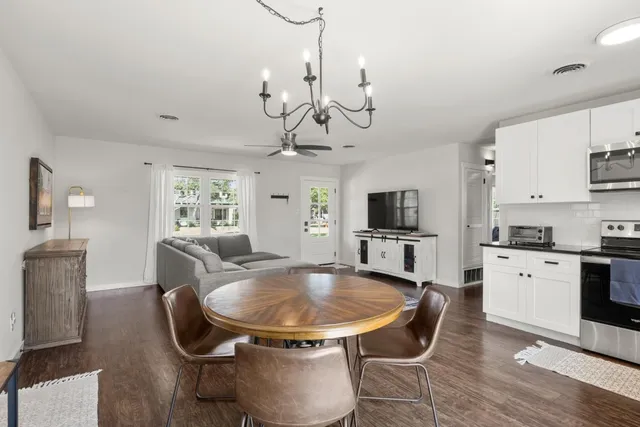 a view of a dining room with furniture and a kitchen
