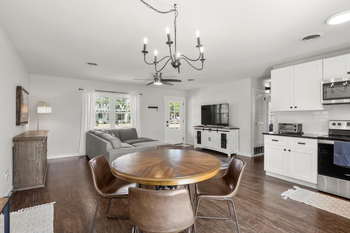 219 Bluff Street Dripping Springs, TX 78620 - Photo 12 of 40 a view of a dining room with furniture and a kitchen