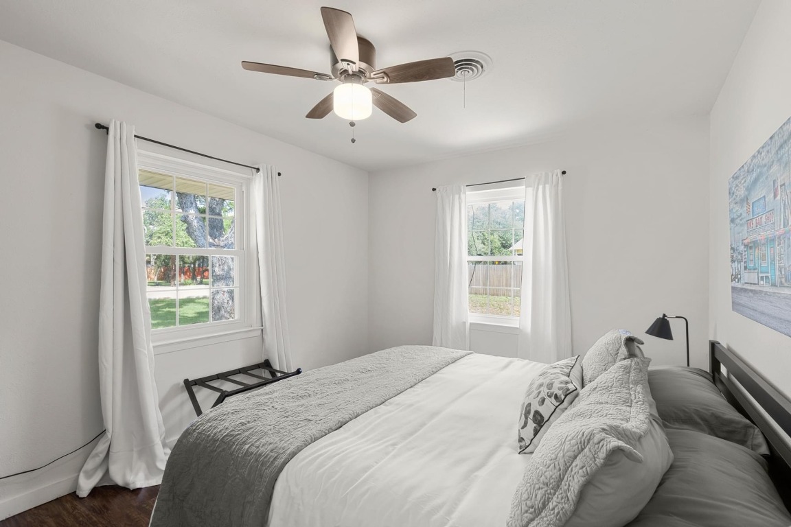 219 Bluff Street Dripping Springs, TX 78620 - Photo 15 of 40 a bedroom with a bed and a window