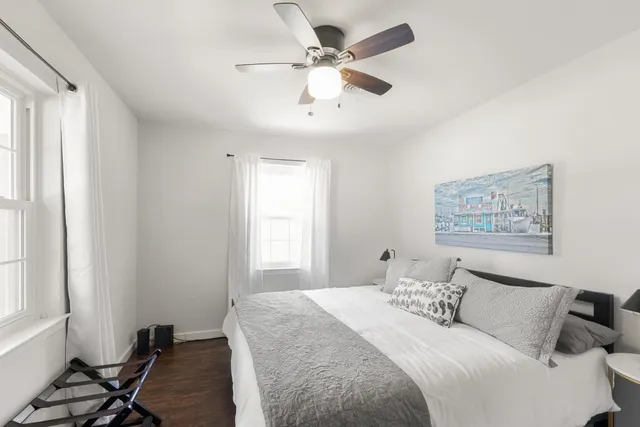 a bedroom with a bed and a window