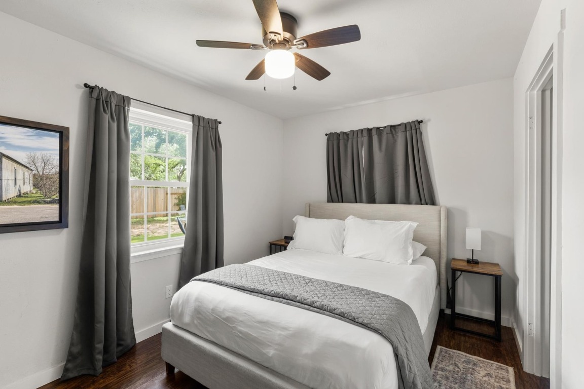 219 Bluff Street Dripping Springs, TX 78620 - Photo 17 of 40 a bedroom with a bed and a window